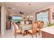 Elegant dining room with chandelier, large window, and access to outdoor patio at 19367 Coastal Shore Ter, Land O Lakes, FL 34638