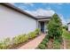 Charming front entrance with brick pathway and landscaped garden at 19367 Coastal Shore Ter, Land O Lakes, FL 34638