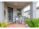 Inviting front porch with rocking chairs, potted plants, and a welcome mat at 19367 Coastal Shore Ter, Land O Lakes, FL 34638