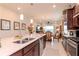 Bright kitchen featuring a center island with seating, stainless steel appliances, and open floor plan at 19367 Coastal Shore Ter, Land O Lakes, FL 34638