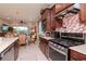 Well-equipped kitchen showcases stainless steel range, custom backsplash, and opens to the dining area at 19367 Coastal Shore Ter, Land O Lakes, FL 34638