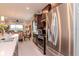 Modern kitchen features stainless steel appliances, dark wood cabinets, and an open layout to the dining area at 19367 Coastal Shore Ter, Land O Lakes, FL 34638