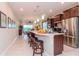 Kitchen with stainless steel appliances, white countertop island and seating at 19367 Coastal Shore Ter, Land O Lakes, FL 34638