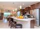 Open kitchen with stainless steel appliances, white countertop island, and pendant lighting at 19367 Coastal Shore Ter, Land O Lakes, FL 34638