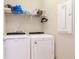 Bright laundry room featuring a modern washer and dryer and wire shelving at 19367 Coastal Shore Ter, Land O Lakes, FL 34638