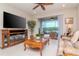 Cozy living room with fireplace, entertainment center, and screened patio access at 19367 Coastal Shore Ter, Land O Lakes, FL 34638
