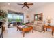 Inviting living room with a ceiling fan, a comfortable sofa, and access to the outdoor patio at 19367 Coastal Shore Ter, Land O Lakes, FL 34638