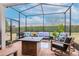 Enclosed patio featuring comfortable seating and a brick floor at 19367 Coastal Shore Ter, Land O Lakes, FL 34638