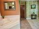 Bright bathroom featuring a large soaking tub, an ornate mirror and a door to another room at 2913 Aston Ave, Plant City, FL 33566