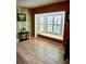 Cozy sitting area features a large window with white shutters, patterned wallpaper and tile floors at 2913 Aston Ave, Plant City, FL 33566