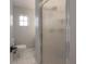 Bright bathroom features updated fixtures, tile flooring and shower with patterned glass at 3611 W De Leon St, Tampa, FL 33609