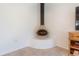 Unique freestanding fireplace on a tile floor with white accents at 3611 W De Leon St, Tampa, FL 33609