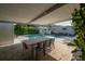 Enjoy outdoor living with a covered patio, dining area, and a view of the pool and garden at 3611 W De Leon St, Tampa, FL 33609