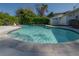Inviting kidney-shaped pool surrounded by a tiled border, perfect for summer relaxation and outdoor enjoyment at 3611 W De Leon St, Tampa, FL 33609