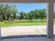 The backyard features a pond surrounded by mature trees and landscape at 422 Shannon Estates Ct, Plant City, FL 33563