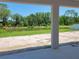 A serene view of the backyard pond framed by the covered patio at 422 Shannon Estates Ct, Plant City, FL 33563
