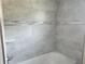 Bathroom tub and tile featuring a decorative accent and shelf for storage at 422 Shannon Estates Ct, Plant City, FL 33563