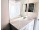 Bathroom vanity featuring a white countertop, white cabinets, a modern faucet, and a large mirror at 422 Shannon Estates Ct, Plant City, FL 33563
