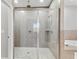 Bathroom shower featuring glass doors, tile surround, and modern fixtures at 422 Shannon Estates Ct, Plant City, FL 33563
