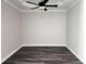 Bedroom featuring a tray ceiling, ceiling fan, and dark wood-look flooring, offering a comfortable retreat at 422 Shannon Estates Ct, Plant City, FL 33563