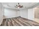 Spacious primary bedroom with vinyl plank flooring, a ceiling fan, and ensuite bathroom at 422 Shannon Estates Ct, Plant City, FL 33563