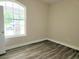A light-filled bedroom featuring stylish floors and a large window at 422 Shannon Estates Ct, Plant City, FL 33563