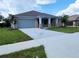 Charming single-story home featuring a brick facade, well-manicured lawn, and a two-car garage at 422 Shannon Estates Ct, Plant City, FL 33563