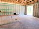 Spacious, unfinished two-car garage showcasing concrete walls and open wood beam ceilings at 422 Shannon Estates Ct, Plant City, FL 33563