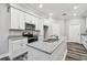 Well-equipped kitchen features white cabinets, granite countertops, and modern appliances at 422 Shannon Estates Ct, Plant City, FL 33563