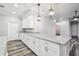 Kitchen bar area features granite countertops, white cabinets, and pendant lighting at 422 Shannon Estates Ct, Plant City, FL 33563