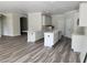 Open kitchen with white cabinets, stainless sink, and an island for seating at 422 Shannon Estates Ct, Plant City, FL 33563