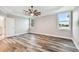 Spacious main bedroom with gray walls, wood-look floors, a ceiling fan, and lots of natural light at 422 Shannon Estates Ct, Plant City, FL 33563