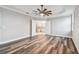 Main bedroom with wood-look floors and a view into the bathroom and walk-in closet at 422 Shannon Estates Ct, Plant City, FL 33563