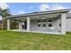 Covered outdoor patio featuring a white swing, ceiling fans, and a nice view of the backyard at 422 Shannon Estates Ct, Plant City, FL 33563