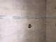 Close-up of a tiled shower featuring neutral tones and blue accent tiles, offering a modern and clean design at 422 Shannon Estates Ct, Plant City, FL 33563