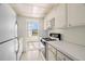 Efficient kitchen design with white cabinets, gas range, and view of a balcony at 5940 30Th S Ave # 209, Gulfport, FL 33707