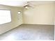 Bright living room featuring tile flooring, a ceiling fan, and a door for easy access and plenty of natural light at 5940 30Th S Ave # 209, Gulfport, FL 33707