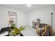 Cozy finished basement space featuring neutral tile, ample lighting, and decoratively staged seating area at 6423 Driftwood Dr, Hudson, FL 34667