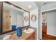 Bright bathroom featuring granite counters, large mirror, and walk-in shower at 6423 Driftwood Dr, Hudson, FL 34667