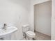Simple bathroom featuring a classic pedestal sink and toilet in a clean, well-lit space at 6423 Driftwood Dr, Hudson, FL 34667