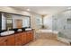 Bathroom featuring double sinks, granite counters, and separate tub and shower at 6423 Driftwood Dr, Hudson, FL 34667