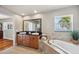 Large bathroom featuring a double vanity, soaking tub, and natural light at 6423 Driftwood Dr, Hudson, FL 34667