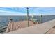 Private boat dock featuring a boat lift and quaint bench, perfect for enjoying serene waterfront moments at 6423 Driftwood Dr, Hudson, FL 34667