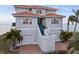 Inviting two-story home showcasing unique architectural details and beautiful tile roofing at 6423 Driftwood Dr, Hudson, FL 34667