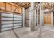 View of the unfinished garage space with cinderblock walls and an automatic door at 6423 Driftwood Dr, Hudson, FL 34667