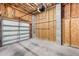 Spacious garage with unfinished walls, concrete floors, and an automatic garage door at 6423 Driftwood Dr, Hudson, FL 34667