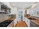 Well-appointed kitchen featuring stainless steel appliances, granite countertops, and wood flooring at 6423 Driftwood Dr, Hudson, FL 34667