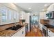 Well-equipped kitchen with white cabinetry, stainless steel appliances, and views of the ocean at 6423 Driftwood Dr, Hudson, FL 34667