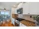 Modern kitchen featuring granite countertops, stainless steel appliances, and tile backsplash at 6423 Driftwood Dr, Hudson, FL 34667