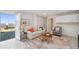 Bright living room with access to the waterfront features neutral decor and tile flooring at 6423 Driftwood Dr, Hudson, FL 34667